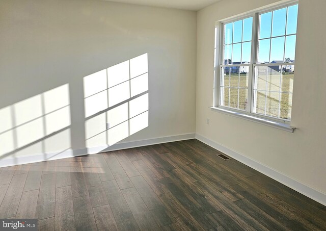 empty room with dark wood-type flooring