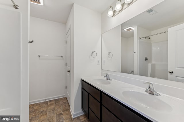 bathroom with vanity and walk in shower