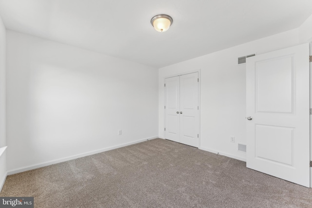 unfurnished bedroom featuring a closet and carpet