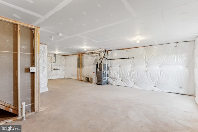 basement with electric panel and heating unit