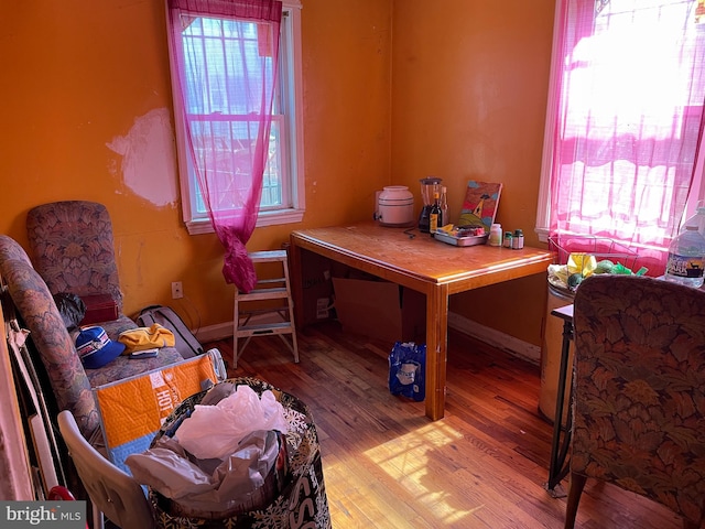 home office featuring light wood-type flooring and a healthy amount of sunlight