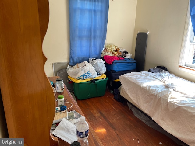 bedroom with dark hardwood / wood-style flooring