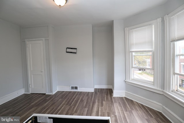 unfurnished room with dark hardwood / wood-style floors