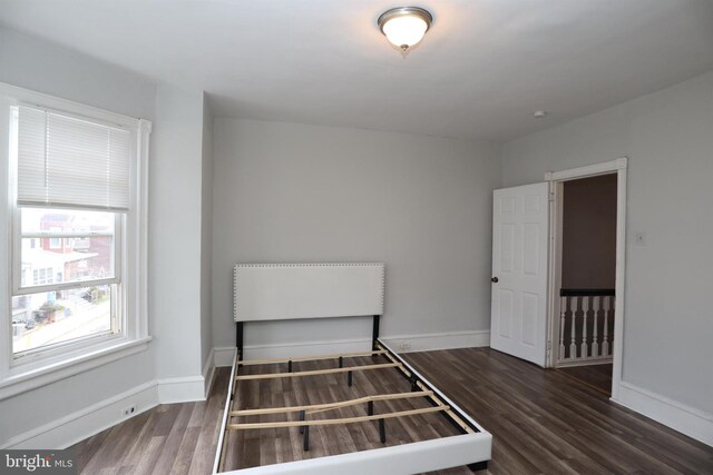 unfurnished bedroom featuring dark hardwood / wood-style floors