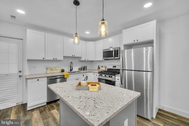 1710 Light St, Baltimore, MD 21230 - kitchen featuring stainless steel appliances, white cabinetry, light stone countertops, and recessed lighting