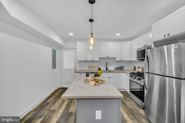 1710 Light St, Baltimore, MD 21230 - kitchen with stainless steel appliances, a center island, white cabinets, dark wood-style flooring, and recessed lighting