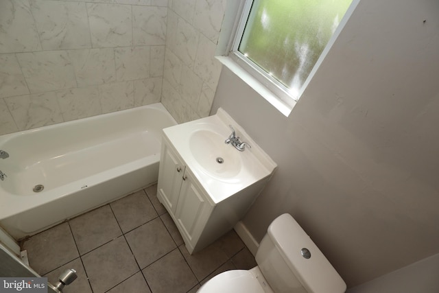 bathroom featuring a bath, vanity, toilet, and tile patterned floors