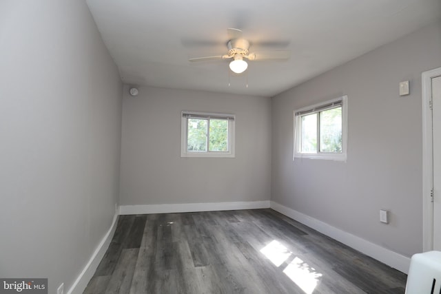 spare room with dark hardwood / wood-style floors and ceiling fan