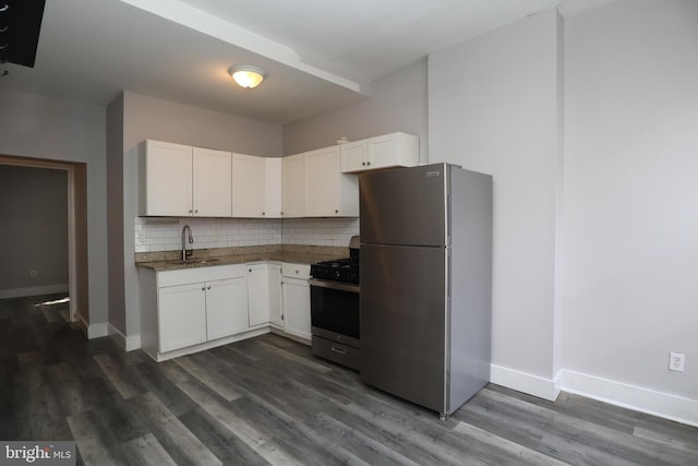 kitchen with white cabinetry, appliances with stainless steel finishes, dark wood-type flooring, and backsplash