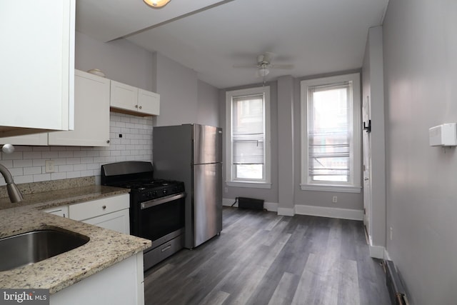 kitchen featuring light stone counters, sink, white cabinets, appliances with stainless steel finishes, and dark hardwood / wood-style flooring