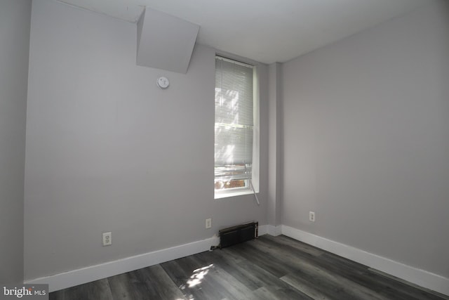 unfurnished room featuring dark hardwood / wood-style flooring