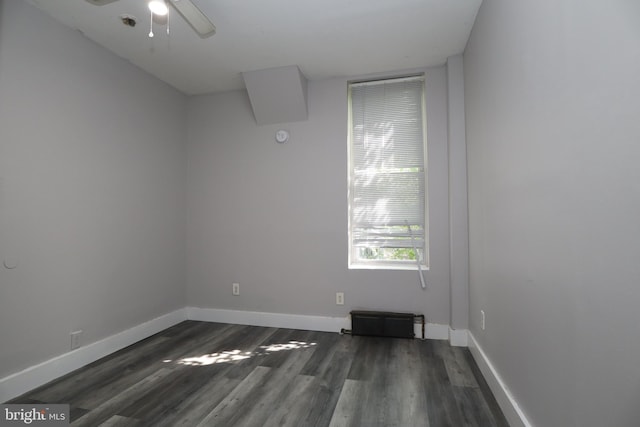 spare room featuring ceiling fan and dark wood-type flooring