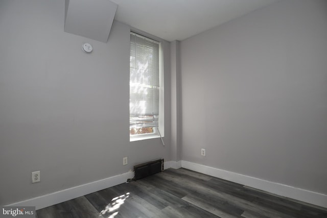 empty room with dark wood-type flooring