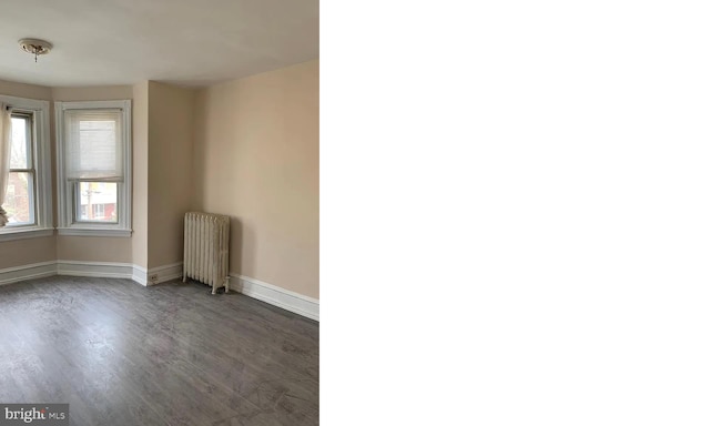 empty room with dark wood-type flooring and radiator