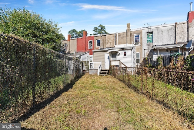 back of property featuring a yard