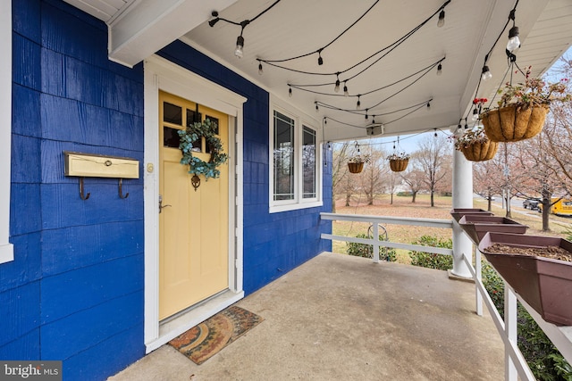 view of exterior entry with covered porch