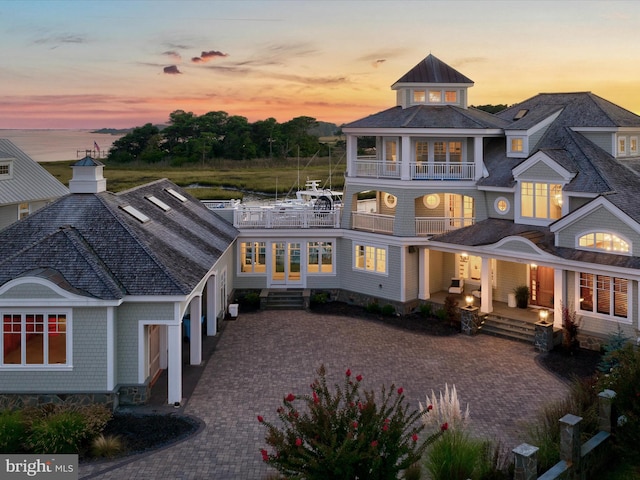 exterior space with a porch and a balcony