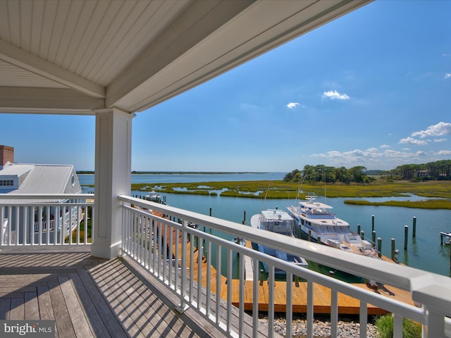 balcony featuring a boat dock and a water view