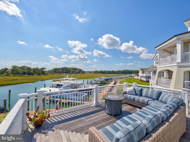 wooden deck featuring an outdoor hangout area and a water view