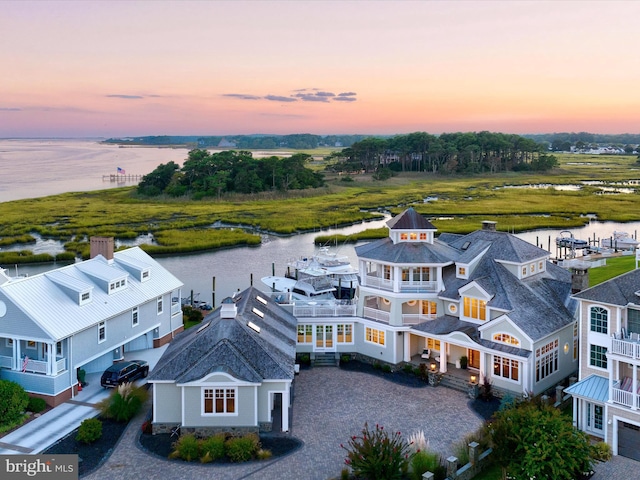 aerial view at dusk with a water view