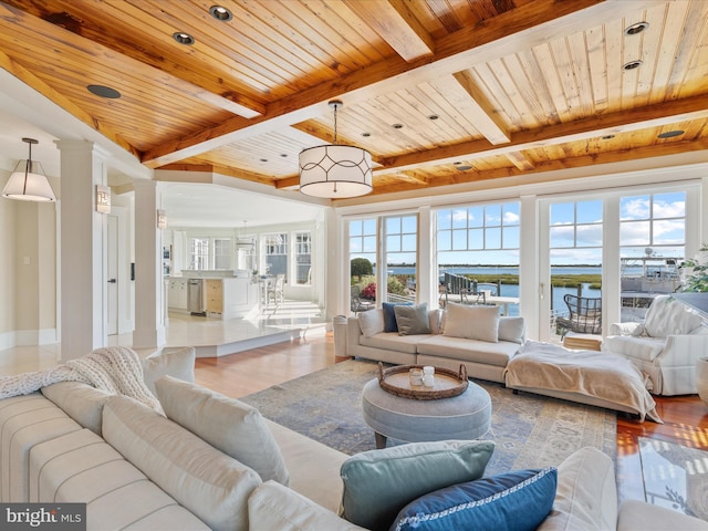 9601 Ocean Vw, Ocean City, MD 21842 - living area with plenty of natural light, beamed ceiling, wood finished floors, and a water view