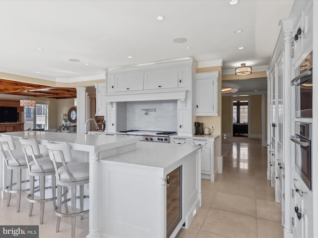 9601 Ocean Vw, Ocean City, MD 21842 - kitchen with plenty of natural light, beverage cooler, backsplash, and oven