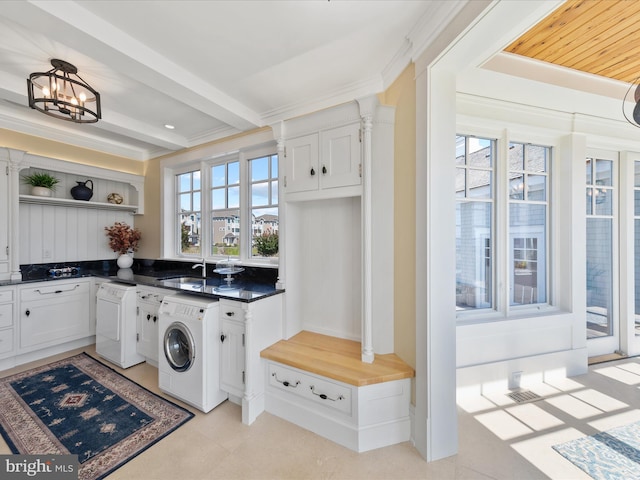 laundry area with washer / clothes dryer, a notable chandelier, and sink