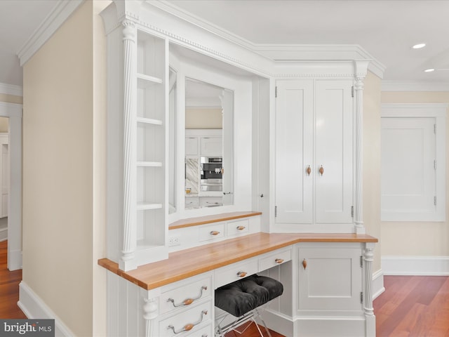 9601 Ocean Vw, Ocean City, MD 21842 - interior space with baseboards, built in study area, wood finished floors, and ornamental molding