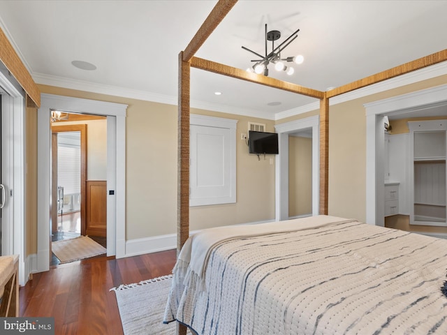 bedroom with dark wood-type flooring, a chandelier, and crown molding