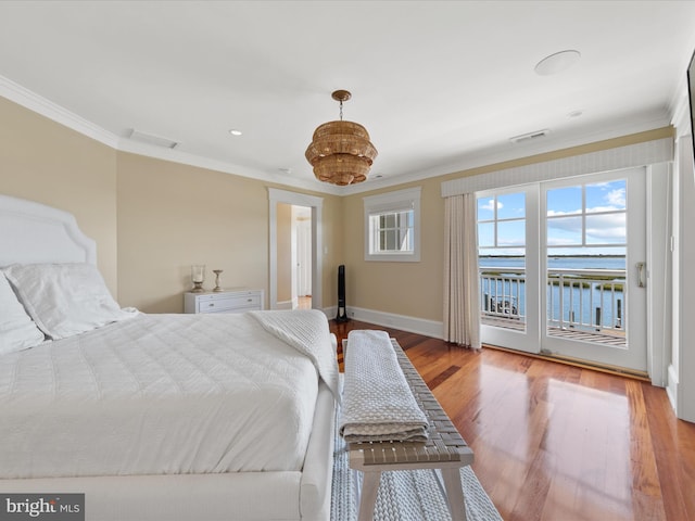 bedroom featuring a water view, light hardwood / wood-style flooring, ornamental molding, and access to exterior