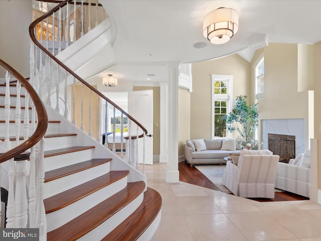 9601 Ocean Vw, Ocean City, MD 21842 - entrance foyer with tile patterned floors, stairway, a fireplace, and baseboards
