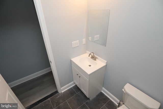 bathroom featuring toilet and vanity