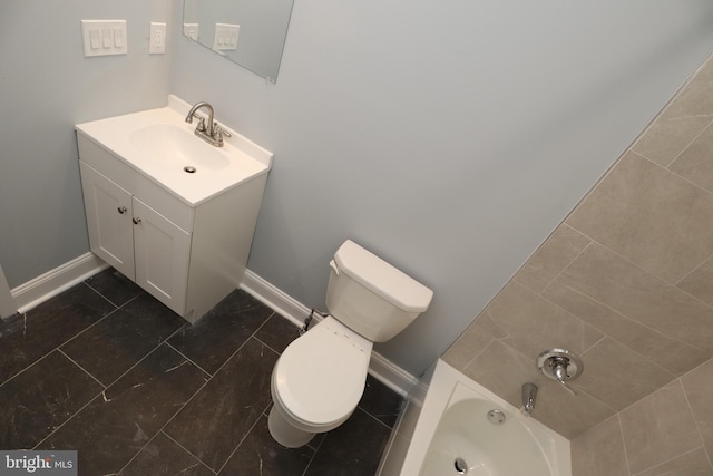 bathroom with vanity, toilet, and a bathing tub