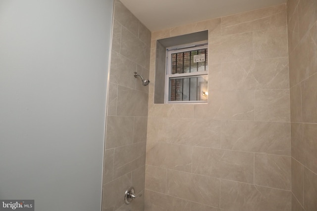 interior details featuring tiled shower