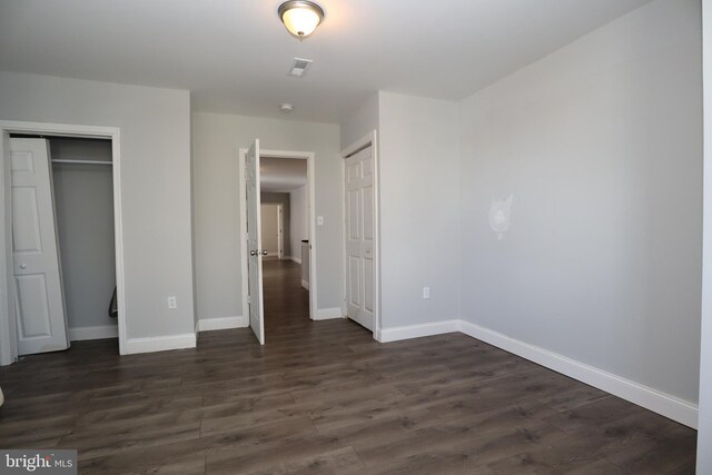 unfurnished bedroom with dark hardwood / wood-style floors