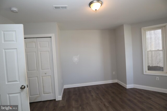 spare room featuring dark hardwood / wood-style flooring