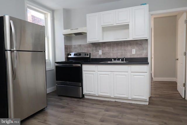 kitchen featuring white cabinetry, stainless steel appliances, sink, decorative backsplash, and dark wood-type flooring