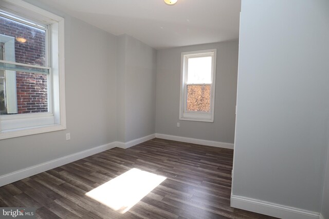 spare room featuring dark hardwood / wood-style floors