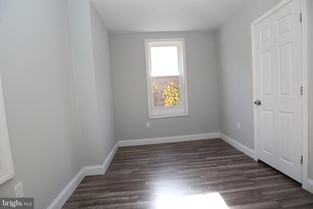 unfurnished bedroom with dark wood-type flooring