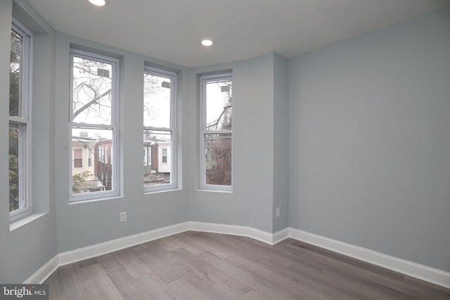 spare room with hardwood / wood-style flooring