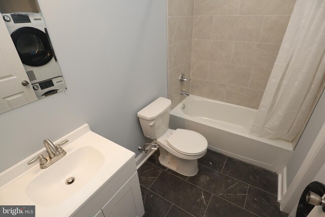 full bathroom with vanity, toilet, stacked washer / drying machine, and shower / bath combo