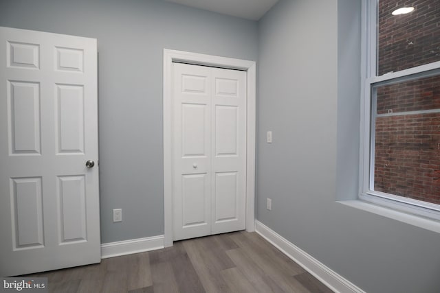 unfurnished bedroom featuring a closet and light hardwood / wood-style floors