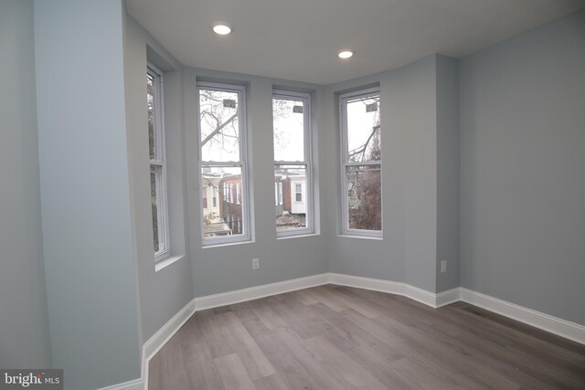 unfurnished room with light wood-type flooring