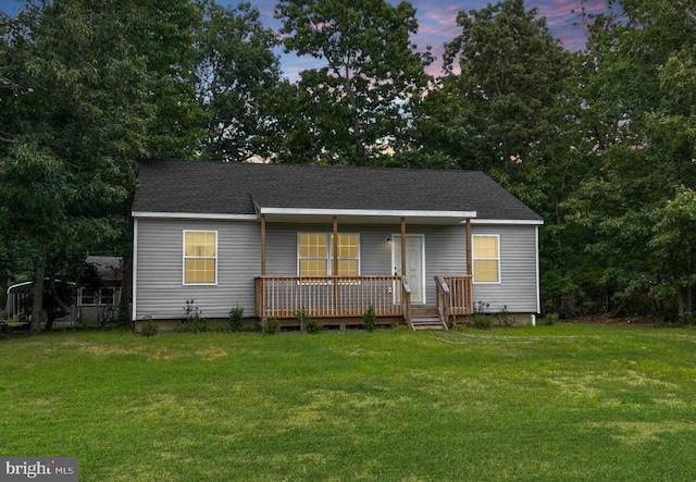 view of front of house with a yard and a deck