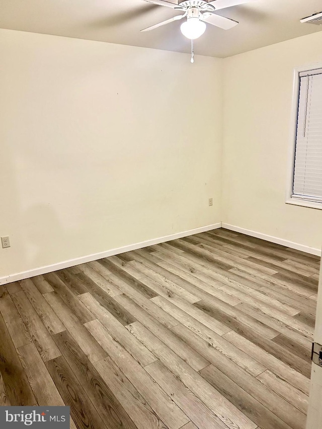 empty room featuring light hardwood / wood-style flooring and ceiling fan