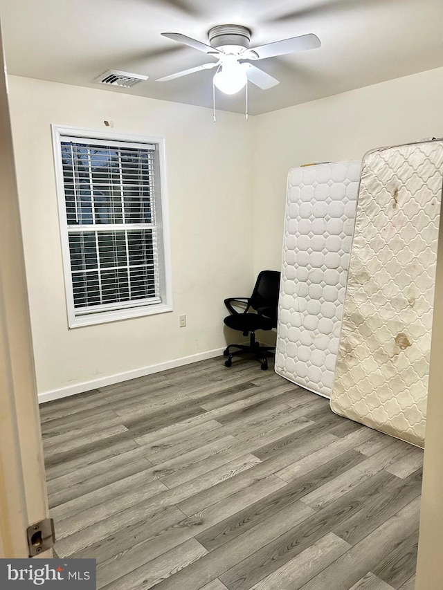 unfurnished room featuring hardwood / wood-style flooring and ceiling fan