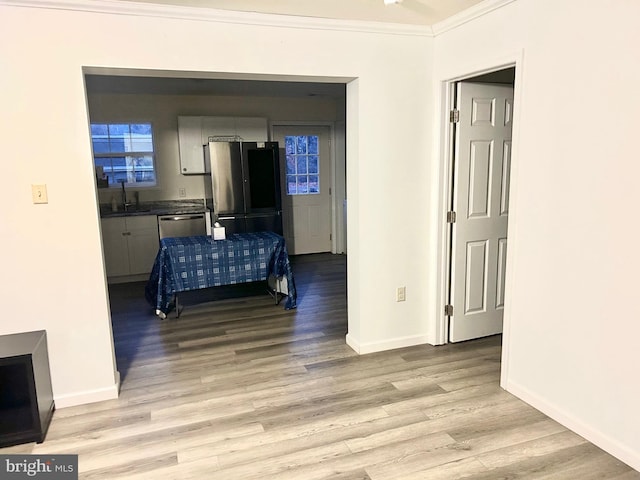5601 Briarwood Dr, Millville, NJ 08332 - corridor with a sink, ornamental molding, baseboards, and light wood-style flooring
