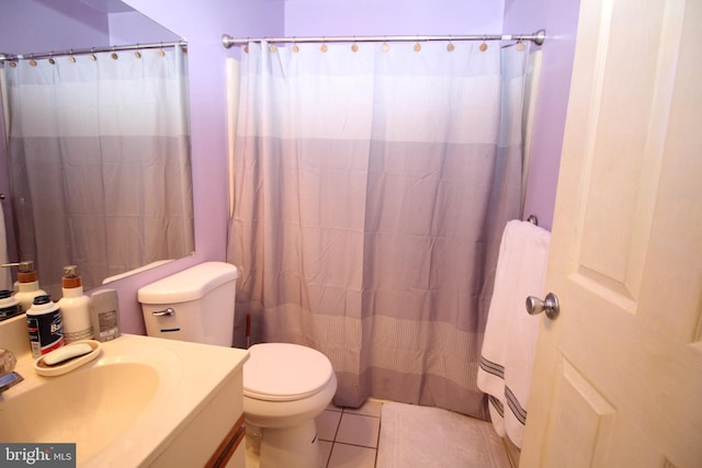 bathroom featuring walk in shower, vanity, toilet, and tile patterned floors