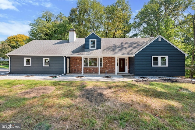 view of front of property with a patio area and a front lawn