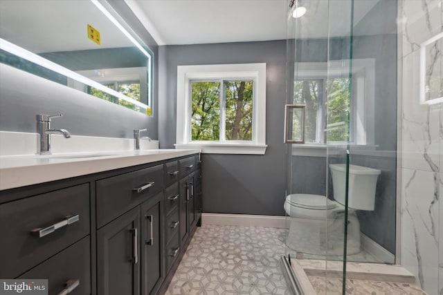 bathroom featuring vanity, toilet, and walk in shower